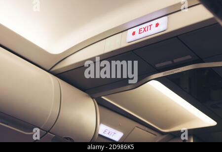 emergency exit sign and toilet sign on airplane Stock Photo