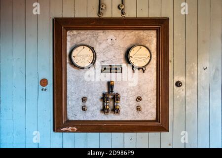 Old electrical indicating instrument on a marble panel Stock Photo