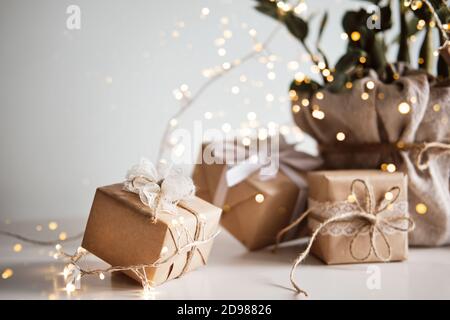 Gift boxes packed in paper, decorated with lace and twine. Eco Christmas decor Stock Photo