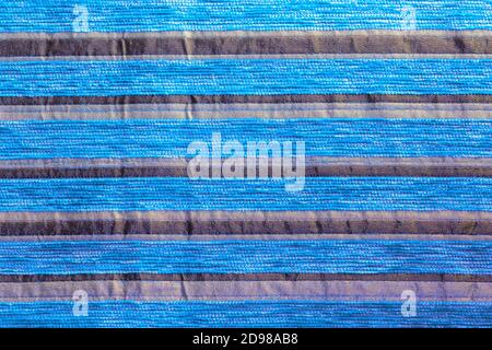 cyan striped synthetic woven upholstery fabric close-up texture Stock Photo