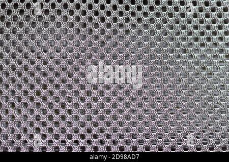 Abstract texture of black metal mesh with fine mesh, curved and deformed. Stock Photo