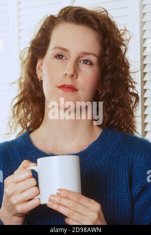 Thoughtful young woman enjoying her morning coffee, USA  1990s Stock Photo