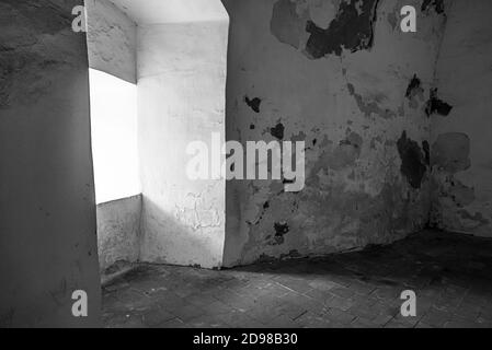 Abandoned dilapidated room with a window. Stock Photo