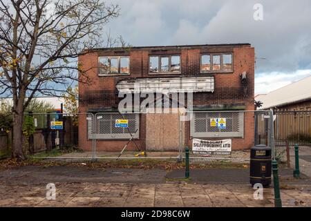 Badly damaged shop building totally destroyed by fire. Stock Photo