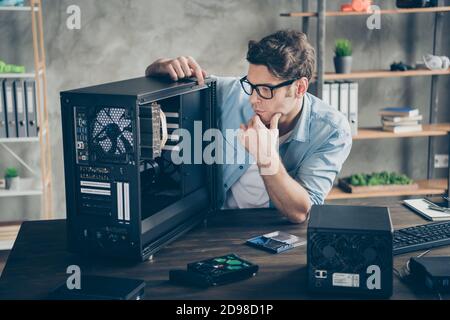 Portrait of his he serious nice attractive focused guy geek skilled expert technician guarantee service testing repairing hardware at modern loft Stock Photo
