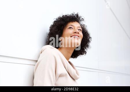 Close up portrait of attractive middle age african american woman smiling in contemplation Stock Photo