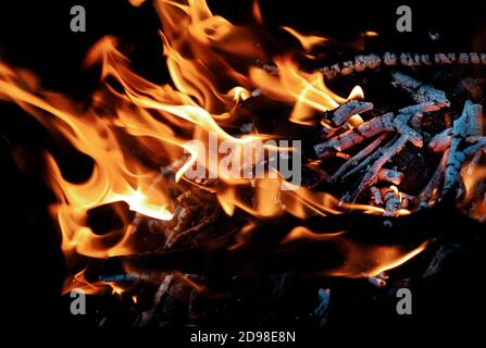 Burning firewood in fireplace close up. A close-up of glowing wood embers Stock Photo