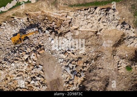 Aerial drone view of excavator working in a limestone quarry Stock Photo