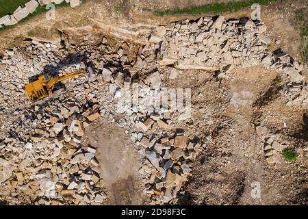 Aerial drone view of excavator working in a limestone quarry Stock Photo