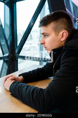 Sad Young Man sit in the Room Portrait closeup Stock Photo