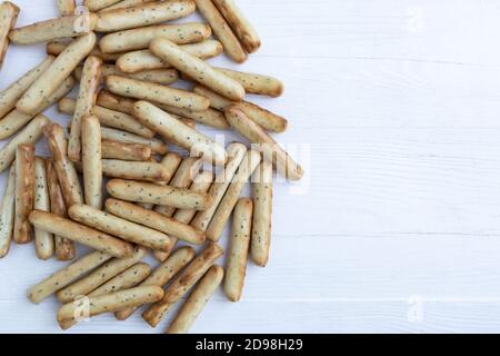 Sticks with poppy seeds on a white background with space for text. Packaging, poster. Stock Photo