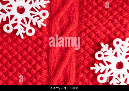 Warm red Christmas sweater with snowflakes as a background, close-up. Layout, postcard template. Stock Photo
