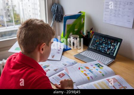 Boy concentrating during homeschooling in corona lockdown Stock Photo