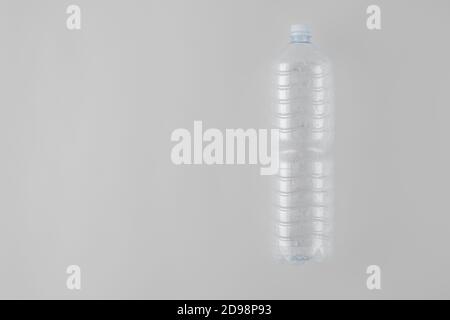 Empty Plastic Water Bottle on Gray Background Stock Photo