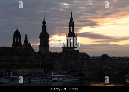 Dresden, Germany. 03rd Nov, 2020. The Ständehaus (l-r), the Hausmannsturm and the catholic court church stand out as silhouettes at sunset. Credit: Sebastian Kahnert/dpa-Zentralbild/ZB/dpa/Alamy Live News Stock Photo