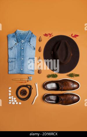 Masculine western outfit still life on a brown background with boots and cowboy hat Stock Photo