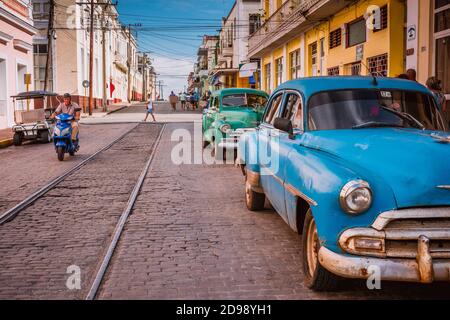 Typical street of Cienfuegos with two 1951 Chevrolet Bel Air. Cienfuegos, Cuba, Latin America and the Caribbean Stock Photo