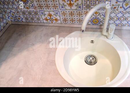 Kitchen sink. Cleanliness and hygiene in conditions of quarantine. Ceramic washbasin. Water mixer Stock Photo