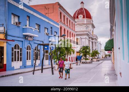 A couple walking, he wears a tshirt of Real Madrid C.F.. Boulevard San Fernando, pedestrian area, in the background the government palace Cienfuegos, Stock Photo