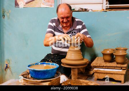 Daniel Chichi Santander, descendant of a family of great tradition in ceramics, working the mud on a potter's wheel. Trinidad, Sancti Spíritus, Cuba, Stock Photo
