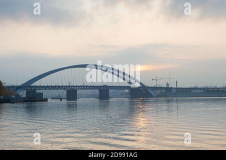 Podilskyi Bridge over the Dnipro river at sunset. Kyiv, Ukraine Stock Photo