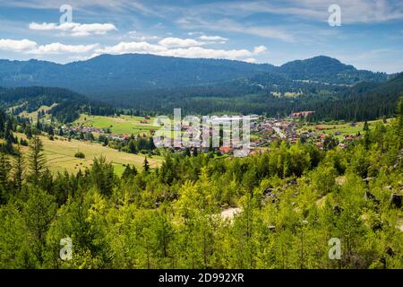 Mountain village in a summer landscape, small village on green valley in Romanian Carpathians. Stock Photo