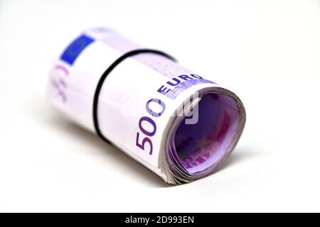 Roll of 500 euro money banknotes in rubber band Stock Photo