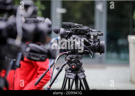 Bucharest, Romania - October 25, 2020: Shallow depth of field (selective focus) image with TV cameras on tripods on a press event in the street. Stock Photo