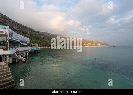 Sea landscape of turquoise idylic water and restaurant in Portinho da Arrabida, Portugal Stock Photo