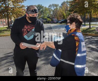 Arlington, VA, November 3, 2020, USA:Voters in Arlington, VA cast their ballots in the Presidential and local elections. Some Biden supporters show th Stock Photo