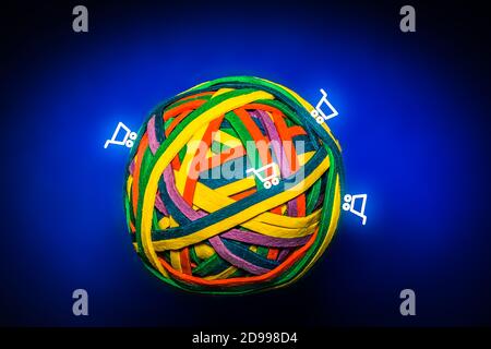 Ball of Colorful Rubber Bands Symbolising the Earth with Shopping Carts Stock Photo