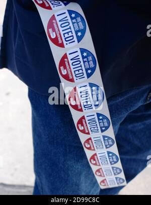 Miami, United States. 03rd Nov, 2020. I Voted stickers hang on the side of a poll worker on election day for the 2020 Presidential Election at the Miami Fire Station 2 in Miami, Florida on Tuesday, November 3, 2020. Lines at the polling sites are shorter than normal due to the amount of voters that early voted or used mail-in ballots. Social distancing is in effect because of COVID-19 pandemic. Photo by Gary I Rothstein/UPI Credit: UPI/Alamy Live News Stock Photo