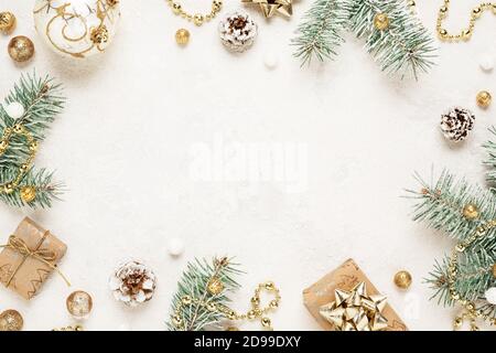 Christmas mood frame of gifts, spruce and gold decorations on white space. Stock Photo
