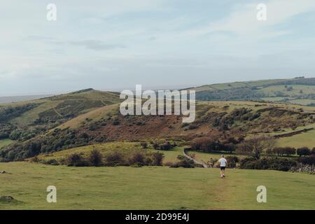 Mendip Hills, UK - October 07, 2020: Rear view of a senior man running in The Mendip Hills, a range of limestone hills to the south of Bristol and Bat Stock Photo