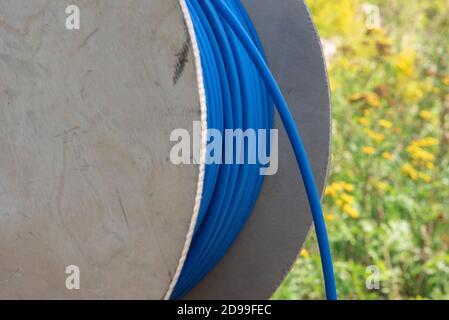 Cable drum with blue network cord closeup Stock Photo