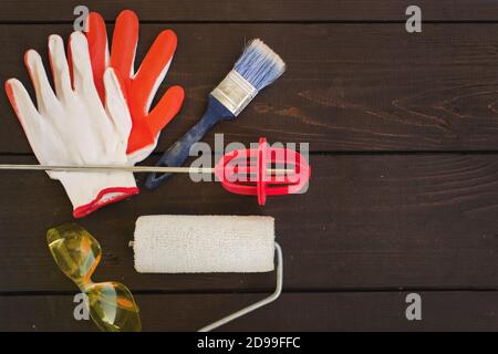 Set of painter's tools on wooden background. Painting tools for home Stock Photo