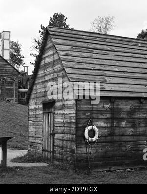 The Iron Warehouse next to its dock on the Saugus River at the Saugus Iron Works. The Saugus Iron Works (originally named Hammersmith) is a national h Stock Photo