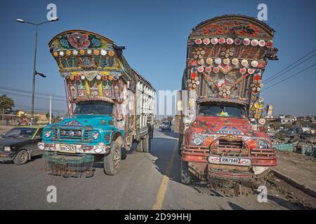 Rawalpindi, Pakistan, December 2008.  Decorated transport trucks typical of the country on one of the crowded roads. Stock Photo
