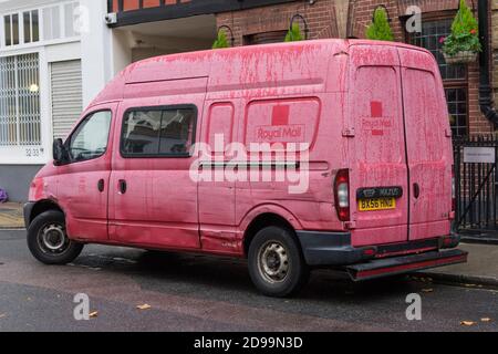 Old Royal Mail delivery van parked in the rain. London Stock Photo