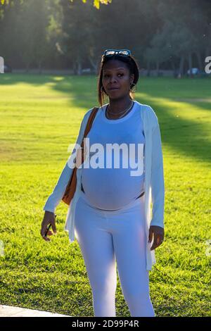 A single, attractive, African-American female getting close to giving birth; Brea Canyon Regional Park, Brea, California, USA. Stock Photo