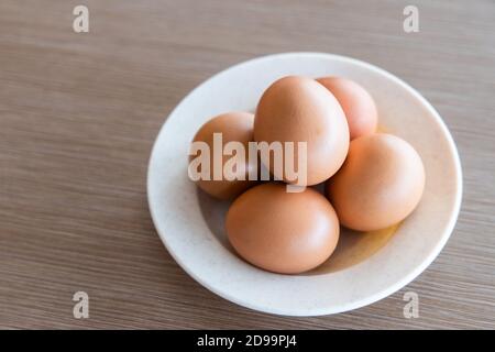 Farm fresh organic chicken eggs on plate with natural light Stock Photo