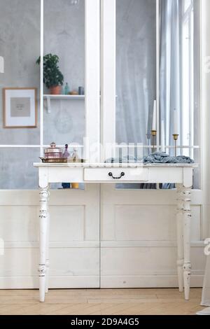 On table are candles cream cosmetics in interior Stock Photo