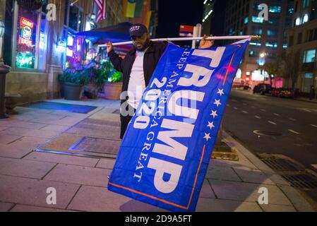 Washington DC, USA, 3rd Nov 2020. Black Trump supporter with flag on election night, Washington DC, USA. Yuriy Zahvoyskyy / Alamy Live News Stock Photo