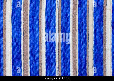 blue vertical striped synthetic woven upholstery fabric close-up texture and background Stock Photo