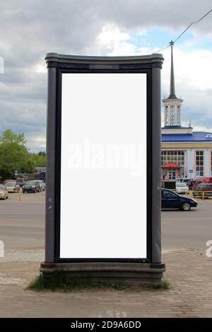 Advertising design with a white vertical rectangular filler. A banner in the city in the summer. A billboard with a place for text and copy space. Stock Photo