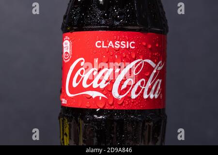 Tyumen, Russia-November 02, 2020: Coca-Cola logo non-alcoholic carbonated drink with water drops produced by the Coca-Cola Company. Stock Photo