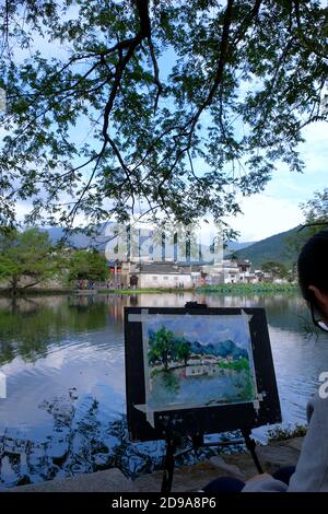 Artist and Easel, impressions of Hongcun Village, UNESCO World Heritage Site, in Huangshan City, China. Stock Photo