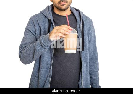 Takeaway coffee concept. Young man body holding paper container with fresh beverage isolated on white background. Stock Photo