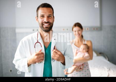 Doctor pediatrician with mother and baby child in clinic. Hospital, examining, child concept. Stock Photo