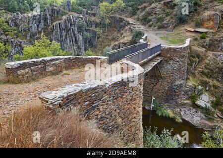 Slate stone bridge in Roblelacasa village. Black architecture. Guadalajara. Spain Stock Photo